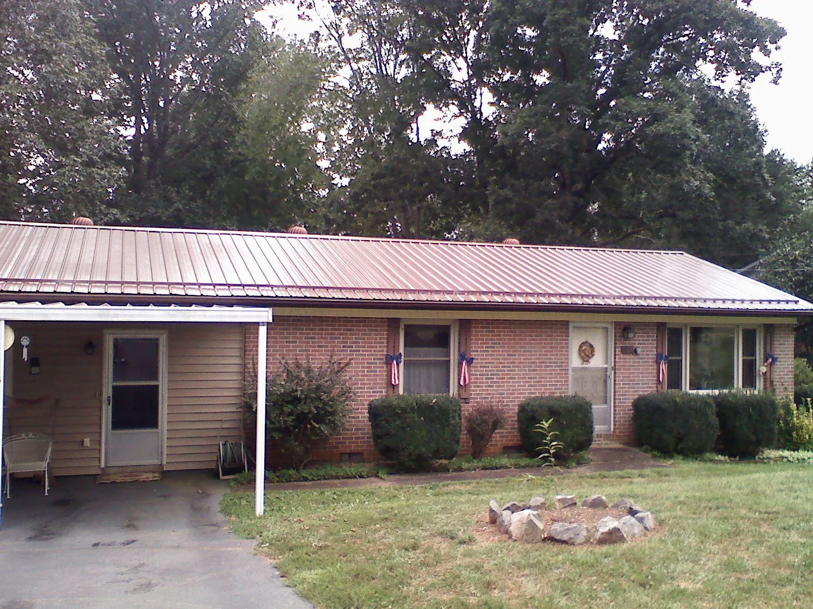 Bronze metal roof and carport on a brick ranch home — Roof Repair work by our crew in Coeur d'Alene