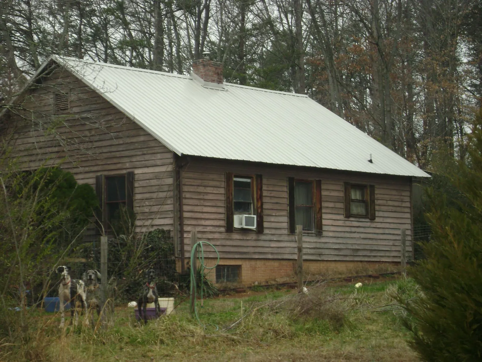 White metal roof on an old wood sided farmhouse, from a Metal Roof Installation job in Coeur d'Alene